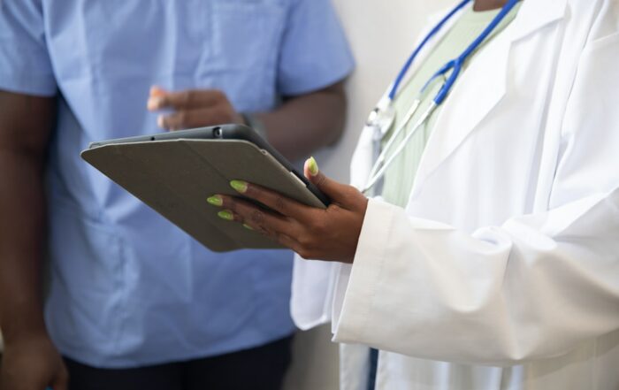 Healthcare professionals reviewing documentation on a tablet — accreditation readiness UAE