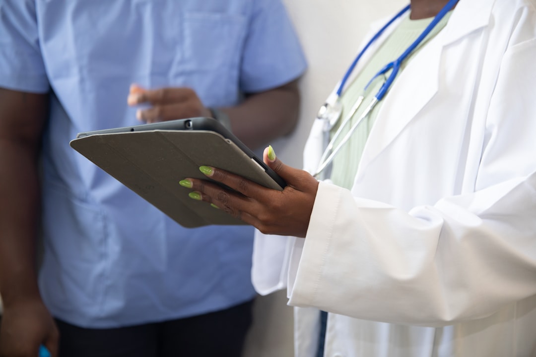 Healthcare professionals reviewing documentation on a tablet — accreditation readiness UAE